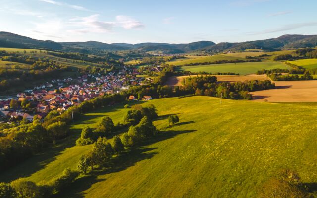 buildings of the village surrounded by grass and trees